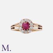 A Fine Ruby and Diamond Cluster Ring in 14 carat yellow gold, comprising a central cushion cut