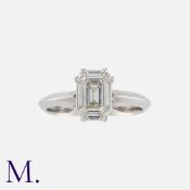 A Diamond Ring in 18 carat white gold, comprising an octagonal cut diamond within a border set