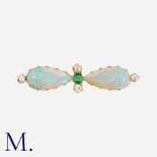 An Antique Opal, Emerald and Diamond Brooch in yellow gold, comprising two pear shaped cabochon