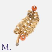 CARTIER, A Coral and Diamond Brooch in 18 carat yellow gold, designed as a leaf, with two diamond-