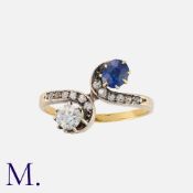 An Edwardian Sapphire and Diamond Toi et Moi Ring in yellow gold and platinum, of crossover deign,