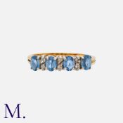 A Blue and White Gemstone Ring in 18K yellow and white gold. Set with four blue gemstones with white
