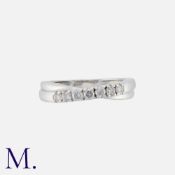 A Diamond 7-Stone Band in 18K white gold, set with seven round cut diamonds weighing approx. 0.