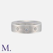 A Diamond-Set Band in 18K white gold with matte finish to the outside of the band, set with three