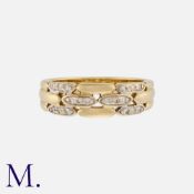 A Diamond Band in yellow gold, set with 18 diamond accents to the front of the band in a brickwork