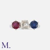 A Ruby, Sapphire and Diamond Ring in white gold, set with a round cut ruby, sapphire and diamond