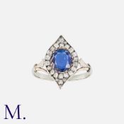 A Sapphire and Diamond Ring in 18K white gold, set with a cushion cut sapphire to the centre with