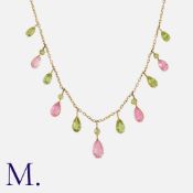 A Tourmaline and Peridot Fringe Necklace in yellow gold, comprising a chain suspending a fringe of