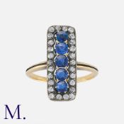 A Sapphire and Diamond Ring in yellow gold and silver, comprising five round cut sapphires within