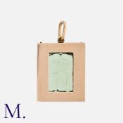 A Green Glass Pendant in 9 carat yellow gold, comprising a rectangular glass plaque featuring the