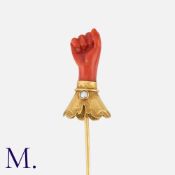 An Antique Figa Pin in 18K yellow gold, set with a carved coral clasped hand with pearl accent.