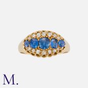 An Antique Sapphire and Diamond Ring in 18 carat yellow gold, set with a central row of blue