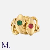 An Antique Snake Ring in 18ct yellow gold set with red and green gemstones. French import mark for