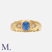 A Sapphire and Diamond Gypsy Ring in 18K yellow gold, set with an oval-cut cornflower blue