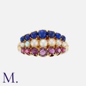 A Lapis Lazuli, Pearl and Ruby Ring in yellow gold, comprising a row of cabochon lapis lazuli, a row