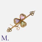 An Antique Shamrock Brooch in yellow gold, set with a three heart-cut gemstones - an amethyst, a