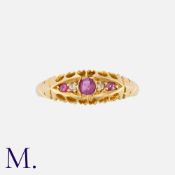 An Antique Ruby and Diamond Ring in 18K yellow gold set with three rubies and diamonds in a pleasant