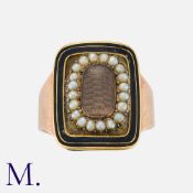 A Georgian Mourning Ring in yellow gold with glazed locket front with pearls in surround and
