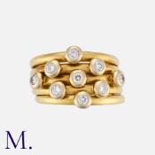 A Diamond Ring in 18 carat yellow gold, comprising five articulated bands, set with round cut