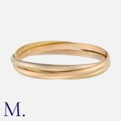 CARTIER. A Trinity Bangle in 18K yellow, white and rose gold (4mm wide). Signed Cartier 1997 and
