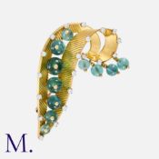 An Aquamarine and Diamond Brooch in 18K yellow gold, set with seven aquamarine beads along the