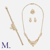 A Diamond Suite in 18 carat yellow gold, comprising a pear shaped, round brilliant and tapered