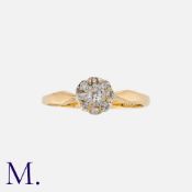 A Diamond Cluster Ring in yellow gold set with round cut diamonds. The centre old cut diamond