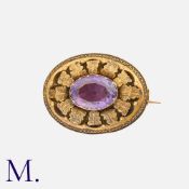 An Antique Amethyst Locket Brooch in yellow gold, the oval cut amethyst within a cluster of stylised