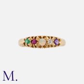An Antique 'ADORE' Acrostic Ring in 18K yellow gold. Set with an amethyst, diamond, opal, ruby and