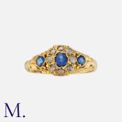 A Sapphire and Diamond in 18 carat yellow gold, set with three round cut sapphires, accented by rose