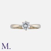 A Diamond Solitaire Ring in 18K yellow and white gold, set with a round brilliant diamond weighing