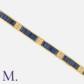 A Sapphire and Diamond Bracelet in 18 carat yellow gold, comprising twelve panels of baguette cut