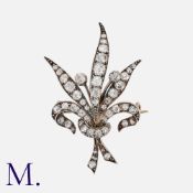 An Antique Diamond Brooch in yellow gold and silver in foliate form, set with old cut diamonds