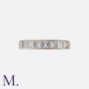A Diamond Band in 18K white gold, channel set with seven princess cut diamonds weighing approx. 1.