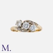 A Diamond 3-Stone Ring in 18K yellow gold and platinum set with three round cut diamonds with