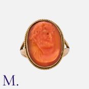 An Antique Coral Cameo Ring in yellow gold, set with carved coral depicting a bearded man. Unmarked;