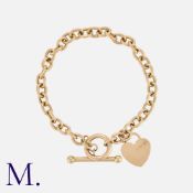 A Gold Toggle Bracelet in 9K yellow gold with a heart charm. Size: 19.0cm Weight: 7.1g