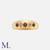 A Garnet and Diamond Gypsy Ring in 18K yellow gold, set with three garnets and two diamonds in