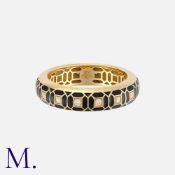 An Enamel And Diamond Ring in 18 carat yellow gold, of geometric design, decorated with black enamel