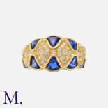 A Sapphire and Diamond Ring in 18 carat yellow gold, set with buffed-top sapphires totalling