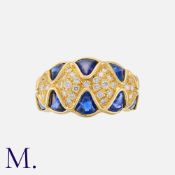 A Sapphire and Diamond Ring in 18 carat yellow gold, set with buffed-top sapphires totalling
