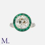 An Old Cut Diamond and Emerald Target Ring in 18 carat white gold, comprising a central old cut