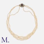 A Natural Saltwater Pearl Necklace comprising three rows of graduated pearls ranging from