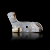 A NEAR EASTERN RECLINING FERRET OR STOAT, BANDED CHALCEDONY. 3rd.mil.B.C.
