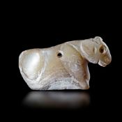AN AMULET IN SHELL IN THE SHAPE OF A RECLINING BOVINE, NEAR EAST, 3RD MILLENNIUM BC