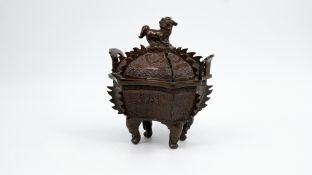 A Chinese covered and footed patinated bronze hexagonal-shaped incense burner