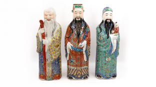 A set of three large Chinese glazed porcelain and Famille rose decorated figures of Fu, Lu, and Shou