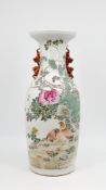 A Chinese Qianjiang and Famille rose decorated porcelain vase with two quails in a garden scene