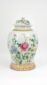 A Chinese Famille rose decorated covered porcelain vase with floral and branch decor