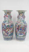 A Chinese pair of Famille rose decorated porcelain vases with a palace and warrior scene